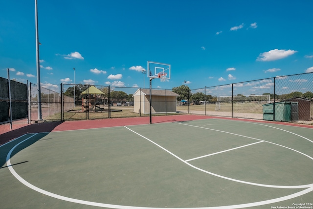 view of basketball court featuring a playground