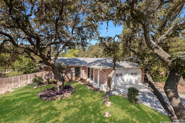 ranch-style house with a front yard and a garage