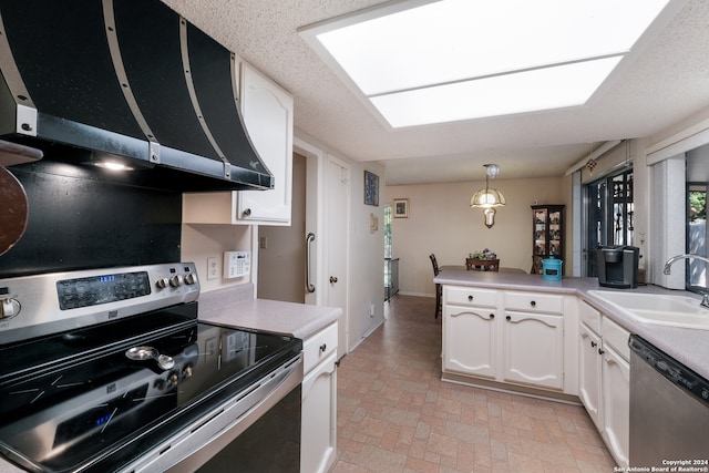 kitchen featuring appliances with stainless steel finishes, sink, pendant lighting, and white cabinets