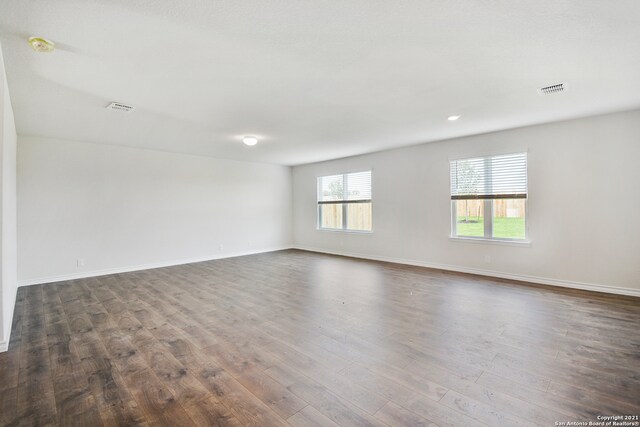 spare room with dark hardwood / wood-style floors