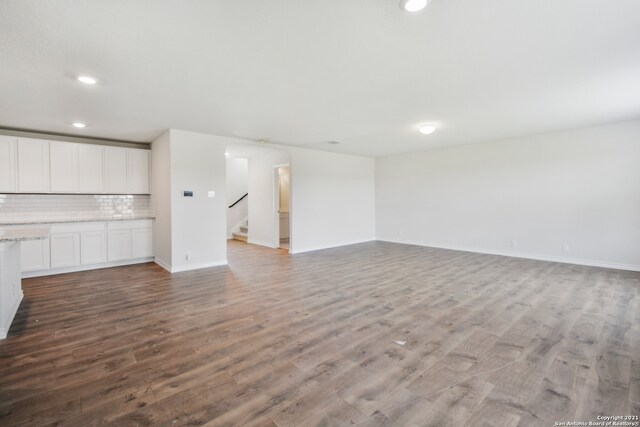 unfurnished living room featuring wood-type flooring