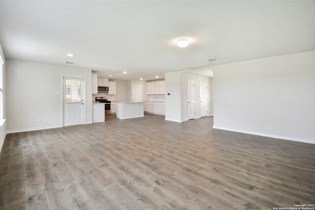 unfurnished living room with light hardwood / wood-style flooring