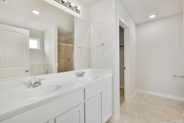 bathroom with tile patterned floors, walk in shower, and vanity