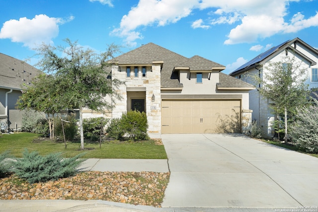 view of front of home featuring a front yard and a garage