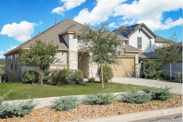 french provincial home with a garage and a front lawn