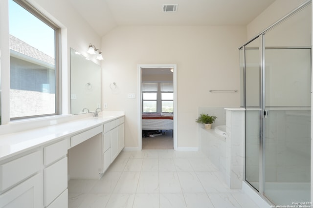 bathroom with independent shower and bath, vanity, and a healthy amount of sunlight