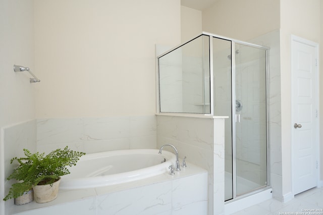 bathroom featuring shower with separate bathtub