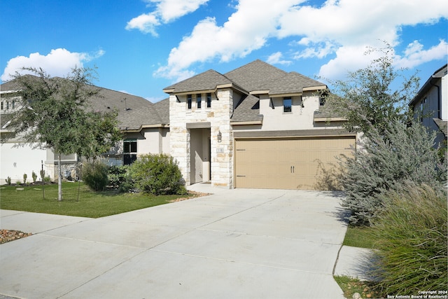 view of front of property with a garage and a front lawn