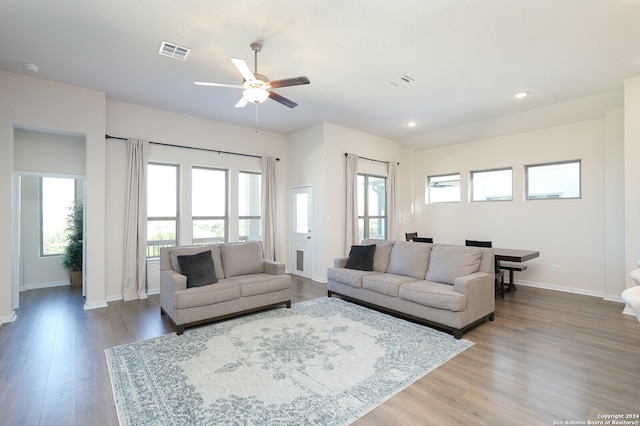 living room with ceiling fan and hardwood / wood-style floors