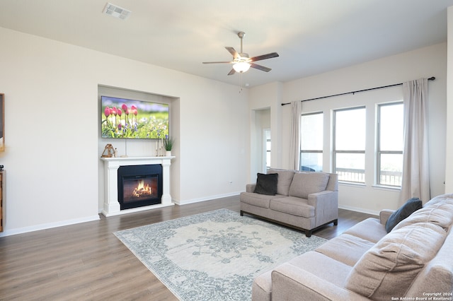 living room with ceiling fan and hardwood / wood-style flooring