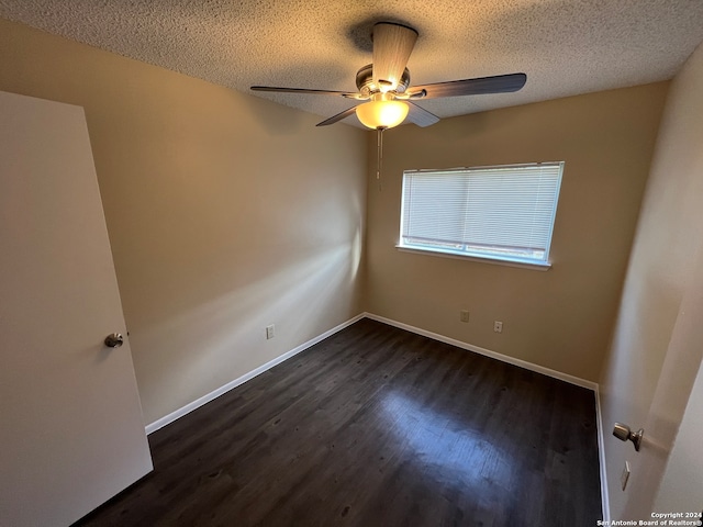 empty room featuring a textured ceiling, ceiling fan, and dark hardwood / wood-style flooring