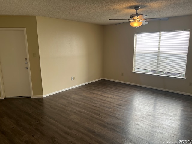 spare room with ceiling fan, a textured ceiling, and dark hardwood / wood-style floors