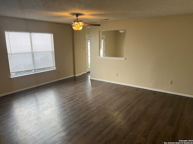 unfurnished room featuring dark wood-type flooring, a textured ceiling, and ceiling fan