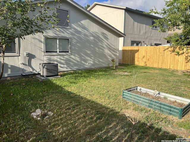 view of yard with central air condition unit