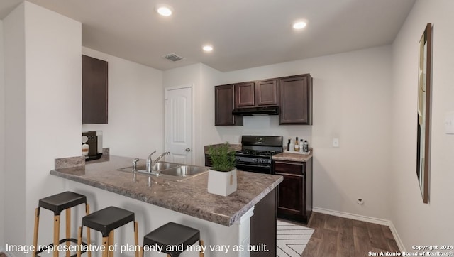 kitchen with sink, kitchen peninsula, black gas range oven, dark hardwood / wood-style flooring, and dark brown cabinetry