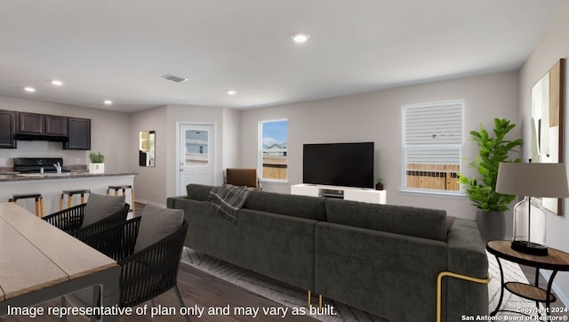 living room with hardwood / wood-style flooring and sink