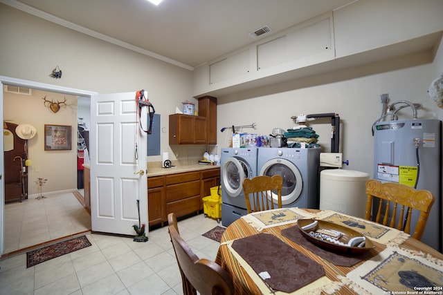 dining area with electric water heater, independent washer and dryer, light tile patterned flooring, and crown molding