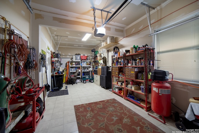 garage featuring a garage door opener and a workshop area