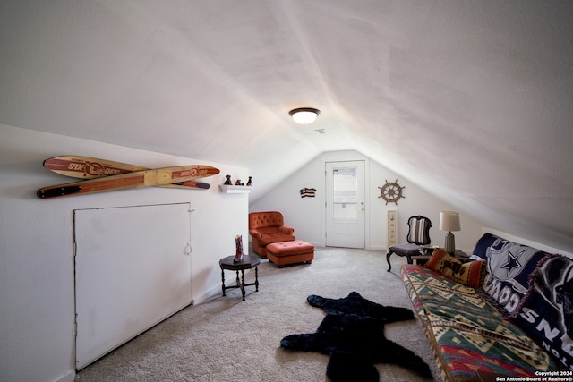 interior space with vaulted ceiling and carpet flooring