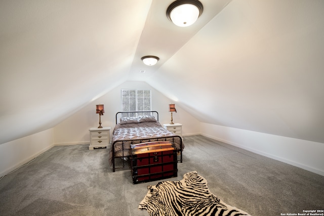 carpeted bedroom with vaulted ceiling