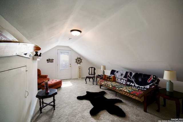 carpeted living room with vaulted ceiling