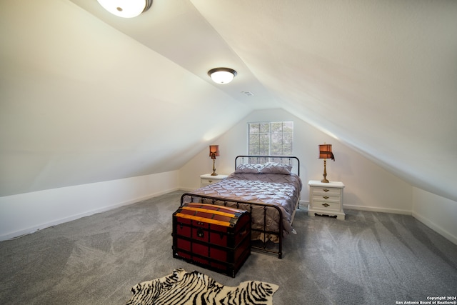 carpeted bedroom with vaulted ceiling