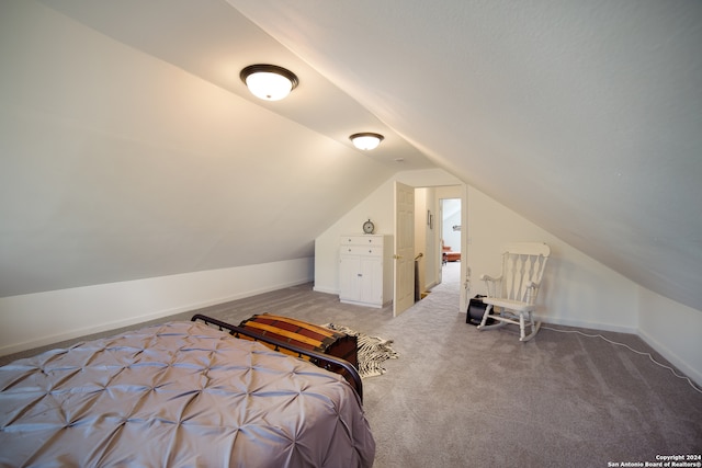 bedroom with carpet and vaulted ceiling