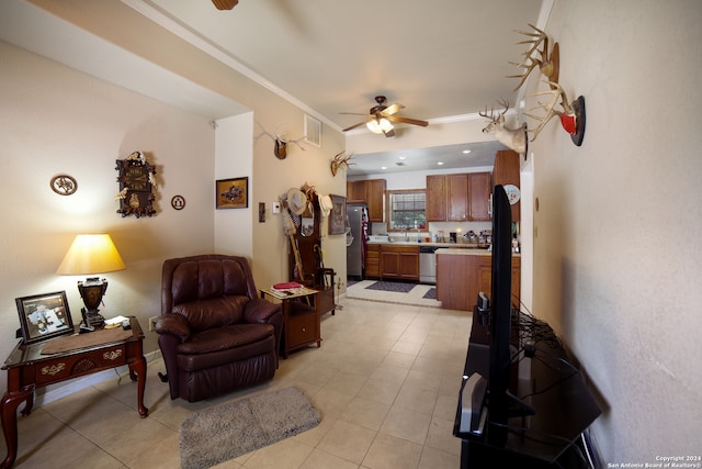 living room with light tile patterned flooring, ornamental molding, and ceiling fan