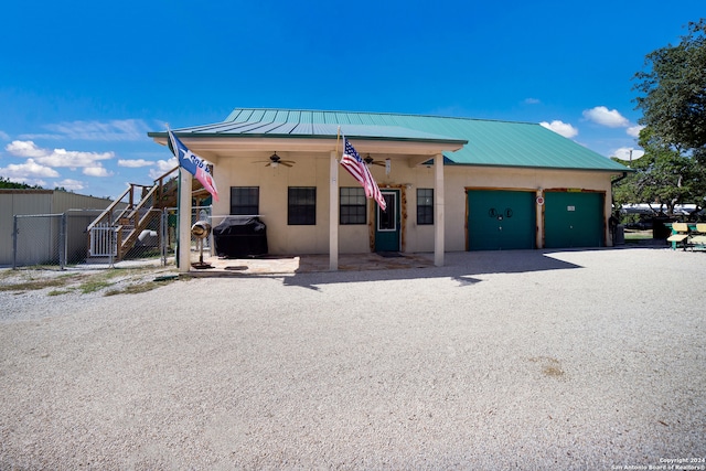 exterior space with ceiling fan and a garage