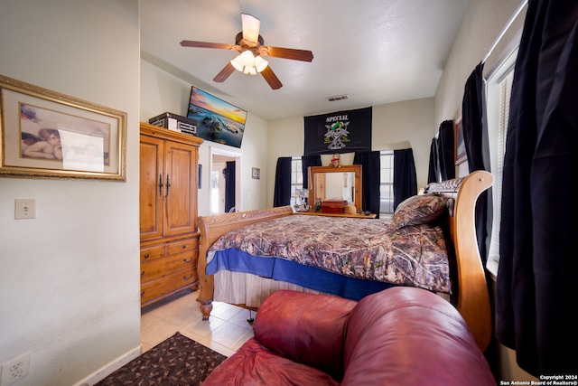 bedroom with ceiling fan and light tile patterned flooring