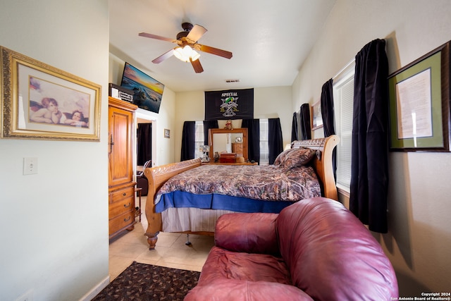 bedroom with ceiling fan and light tile patterned floors