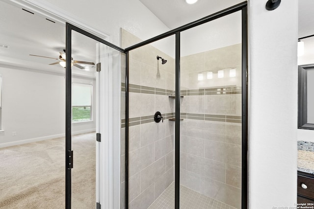 bathroom featuring ceiling fan and a shower with shower door