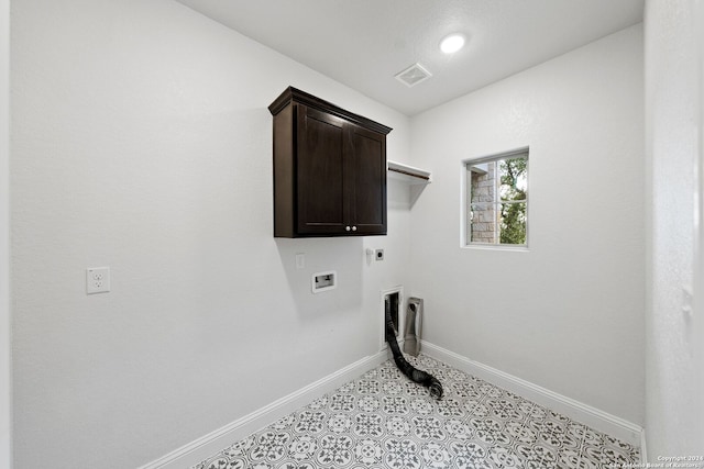 laundry room with hookup for a washing machine, cabinets, and electric dryer hookup