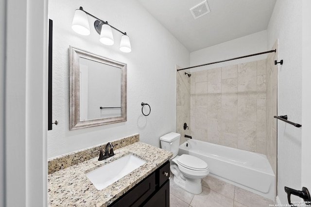 full bathroom featuring tile patterned flooring, vanity, toilet, and tiled shower / bath