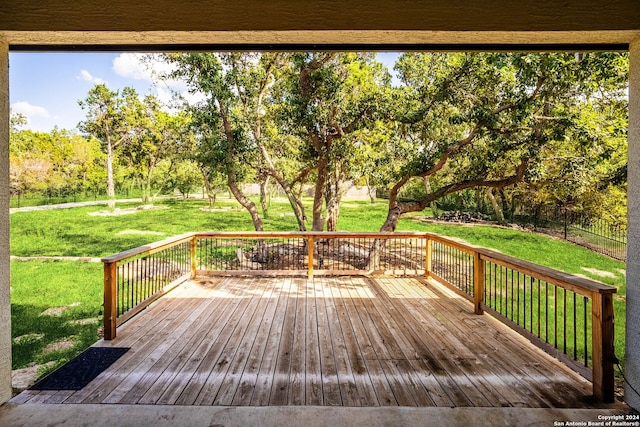 wooden terrace featuring a yard