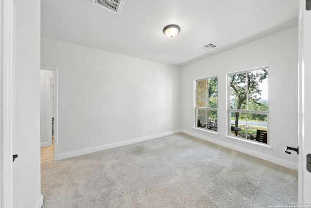 empty room featuring light carpet