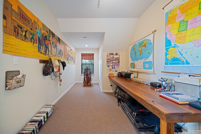 carpeted home office featuring lofted ceiling