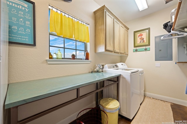 clothes washing area with cabinets, electric panel, and separate washer and dryer