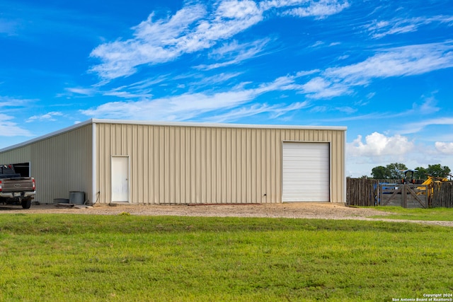 view of outbuilding with a garage and a yard