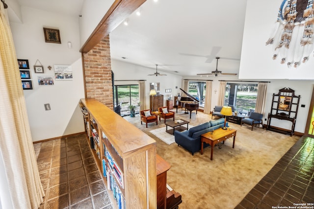 living room with dark tile patterned flooring, vaulted ceiling with beams, and ceiling fan