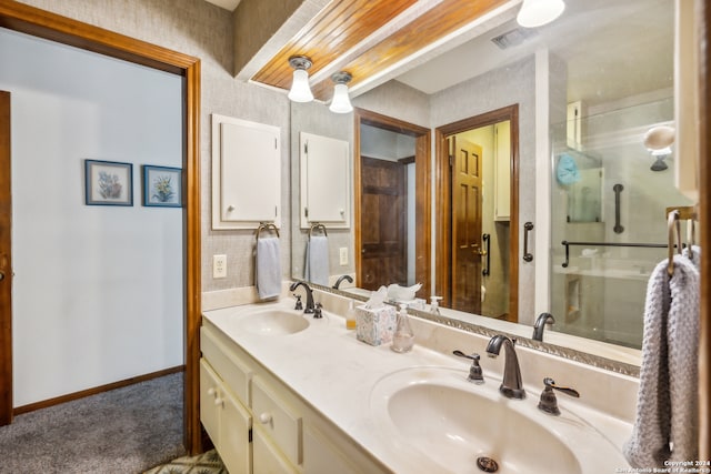 bathroom featuring vanity and an enclosed shower