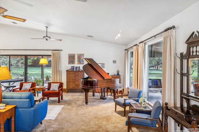 living room featuring ceiling fan, lofted ceiling, and a wealth of natural light