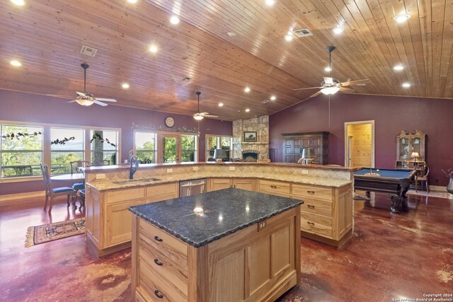 kitchen with a large island with sink, sink, and ceiling fan