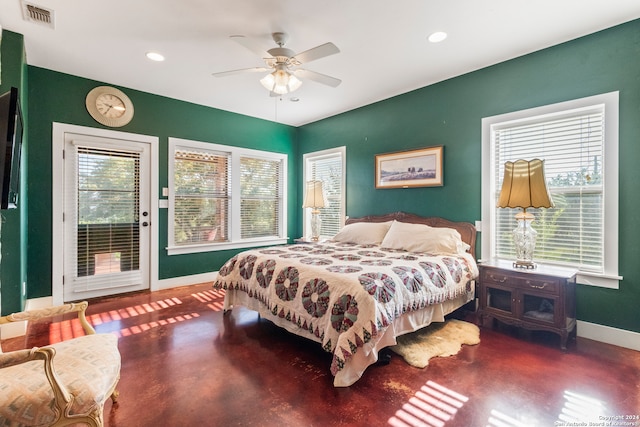 bedroom with ceiling fan, access to outside, and multiple windows