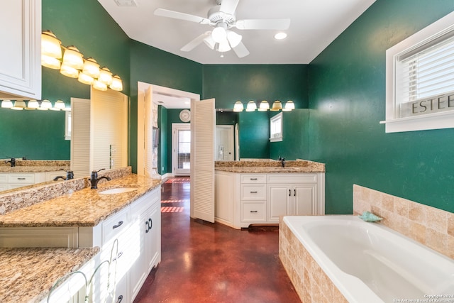 bathroom featuring a bath, concrete floors, vanity, and ceiling fan