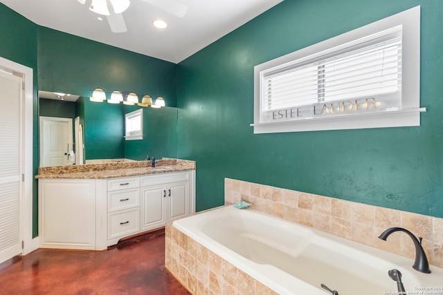 bathroom with vanity, ceiling fan, concrete floors, and a relaxing tiled tub