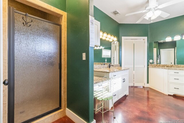 bathroom with ceiling fan, vanity, a shower with shower door, and concrete floors