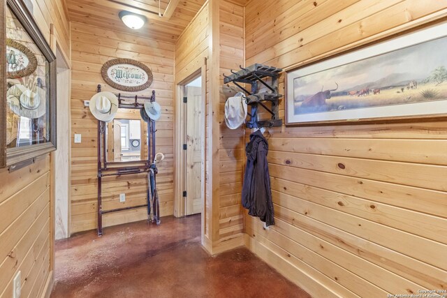 corridor featuring wood walls