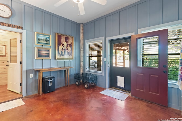 entrance foyer with ceiling fan and concrete floors