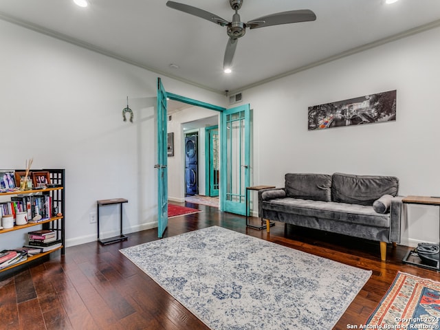 living room featuring ceiling fan, crown molding, and dark wood-type flooring